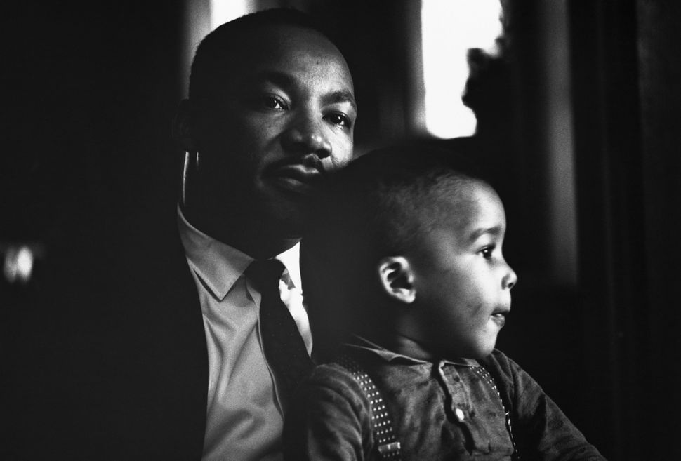 Martin Luther King Jr. holds his young son Dexter on his lap at home in Atlanta, November 8, 1960.