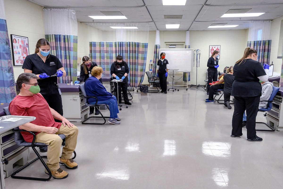 MTSU School of Nursing students administer the free Moderna COVID-19 vaccine to eligible community residents Thursday, Feb. 25, in Cason-Kennedy Nursing Building clinical area. It marks the first day of the School of Nursing partnership with the Rutherford County Health Department in providing the vaccine by appointment only on Thursdays and Saturdays in the coming weeks. (MTSU photo by J. Intintoli)