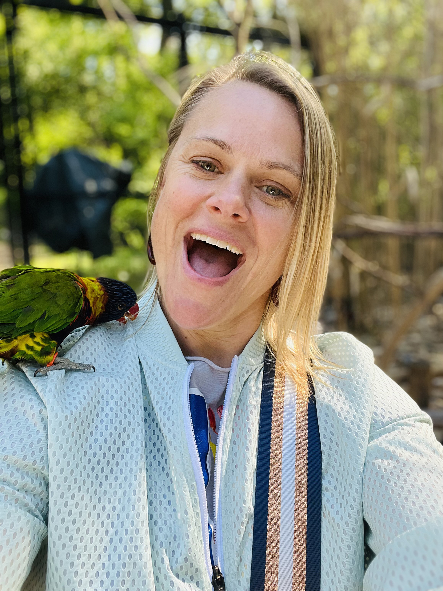Mom Reporter Janae enjoys a Lorikeet on her shoulder!